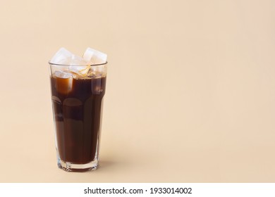 cold iced coffee on a beige background, minimalism, summer drink