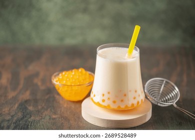 Cold iced fruit bubble tea with juice balls in glass