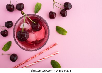 Cold Lemonade With Cherries The Glass On The Pink  Background.Top View.Copy Space.