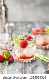 Cold Lychee And Raspberry Cocktail. The Summer Tropical Refreshing Litchi  Drink On A Gray Wooden Background