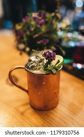 Cold Moscow Mule Cocktail In Copper Mug On Wooden Bar Desk At Restaurant Or Cafe From Top View.