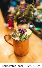 Cold Moscow Mule Cocktail In Copper Mug On Wooden Bar Desk At Restaurant Or Cafe From Top View.