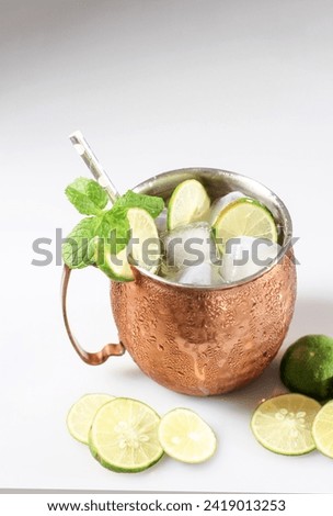 Cold Moscow Mules Cocktail with Ginger Beer, Vodka, Lime, and Mint Leaf. On White ackground 