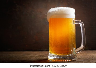 Cold Mug Of Beer On A Wooden Table