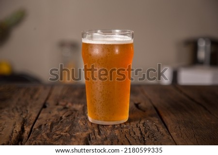 A cold pint of american pale ale beer in a restaurant