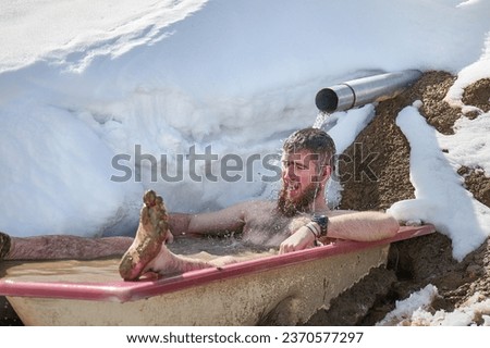Cold plunge, outdoor cold water immersion in an old bathtub left by a spring, cold exposure ice bath