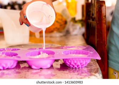 Cold Pour Pink Soap Mix Being Poured Into Pink Molds For Home Made Soap. This Hobby And Home Business Creates Exotic Aromatherapy Organic Safe Soaps For Luxury Indulgence Use