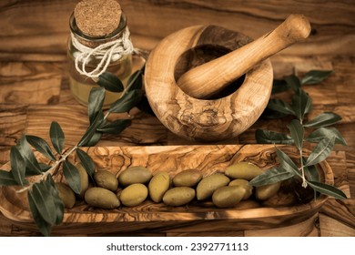 cold pressed extra virgin olive oil on olive wood
