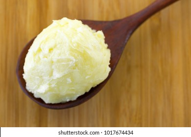 Cold Pressed Unrefined Shea Butter Fat Extracted From Nut Seed Of African Shea Tree In Wooden Spoon (Vitellaria Paradoxa)
