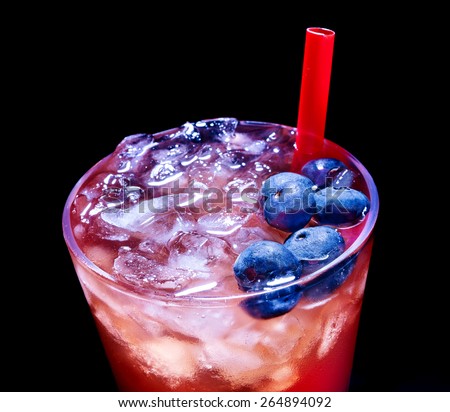Cold red blueberry drink  with berry and straw. Top view. Close up.