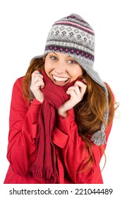 Cold redhead wearing coat and hat on white background