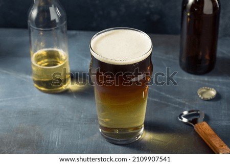 Cold Refreshing Snakebite Cider and Stout Cocktail in a Glass