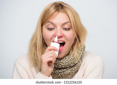 For Cold Relief. Unhealthy Girl With Runny Nose Using Nasal Spray. Sick Woman Spraying Medication Into Nose. Cute Woman Nursing Nasal Cold Or Allergy. Treating Common Cold Or Allergic Rhinitis.