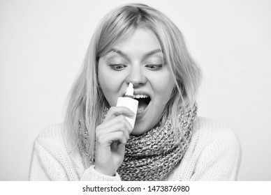 For Cold Relief. Unhealthy Girl With Runny Nose Using Nasal Spray. Sick Woman Spraying Medication Into Nose. Cute Woman Nursing Nasal Cold Or Allergy. Treating Common Cold Or Allergic Rhinitis.