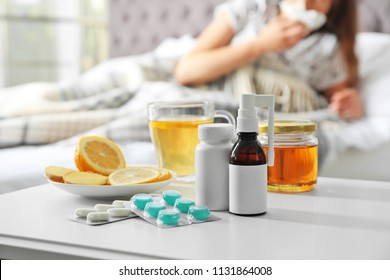 Cold Remedies And Sick Woman On Background Indoors