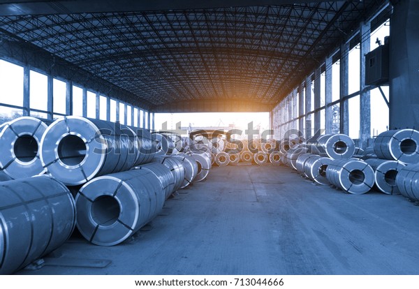 Cold rolled steel coil at storage area in steel\
industry plant. Vintage blue\
tone
