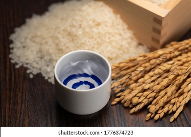 Cold sake with rice and ear of rice  on the table