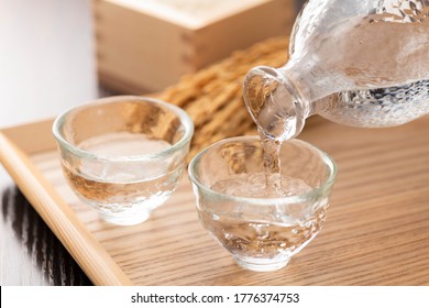 Cold sake with rice and ear of rice  on the table