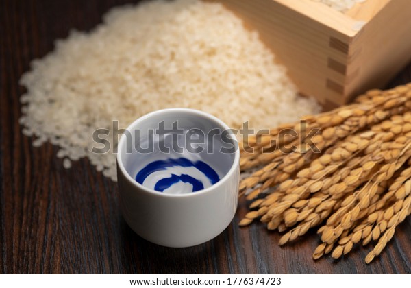 Cold sake\
with rice and ear of rice  on the\
table
