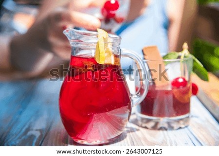 Cold serving of cherry liqueur on a wooden table...liker od višnje 