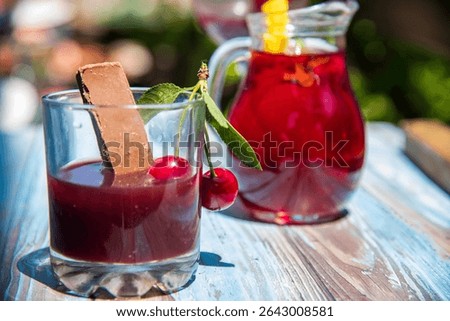 Cold serving of cherry liqueur on a wooden table...liker od višnje
