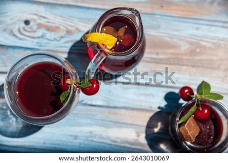 Cold serving of cherry liqueur on a wooden table...liker od višnje