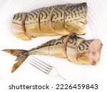 Cold smoked chopped fish on a white plate with fork