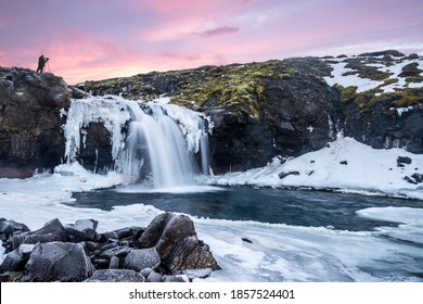 

A cold snowy waterfall in the highlands of Iceland framed by pastel skies and rugged terrain offers scenic landscape epitomizing the frozen wilderness. 

 - Powered by Shutterstock