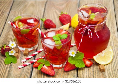 Cold Strawberry Drink With Fresh Strawberries And Lemon On Wooden Background