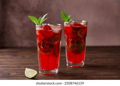 Cold strawberry Mojito cocktail with lime, ice and mint on a brown wooden table. Sugar free, nonalcoholic. - Powered by Shutterstock