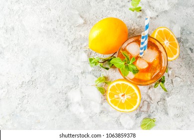 Cold Summer Drink. Iced Tea With Lemon And Mint, On Grey Stone Background.  Copy Space Top View