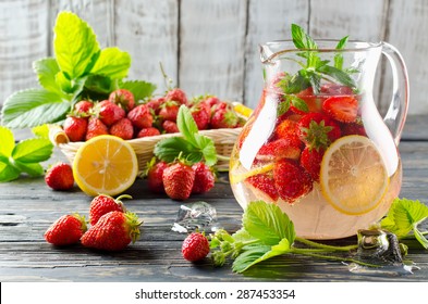 Cold summer drink with mint, strawberry and lemon