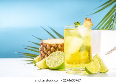 Cold summer tropical drink with crushed ice, lime and mint. Sweet pineapple lemonade copy space