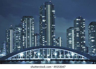 Cold Toned Cityscape Of Night Tokyo, Modern Buildings At Tsukishima District And Eitai Bridge