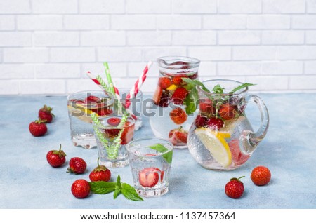 Cold transparent drink with fruit in the glass on the table. Selective focus.