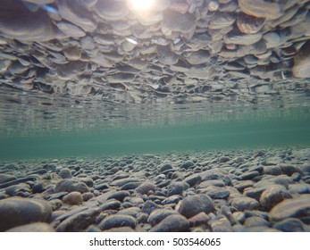 Cold Underwater River Bed With Perfect Reflection On Surface Tension