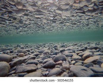 Cold Underwater River Bed With Perfect Reflection On Surface Tension