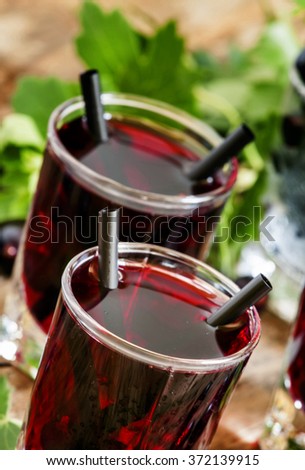 Cold vodka with blackcurrant juice and fresh berries, selective focus