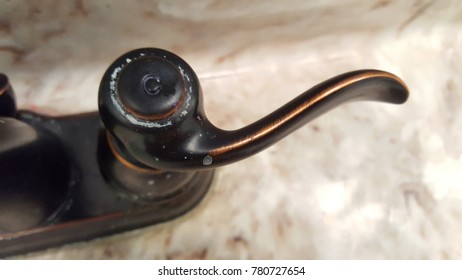 Cold Water Faucet Handle With Hard Water Stains And Bronze Finish