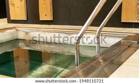 Cold water plunge pool in the spa and wellness center. Pool with very cold water for body hardening. The contrast temperature of the water after steaming in the sauna.