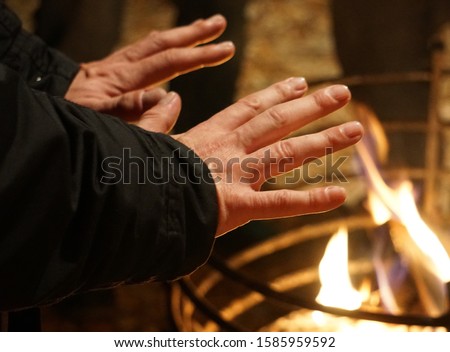 Cold Weather. Fire Flame And Hands Warm. Christmas Market, Germany.