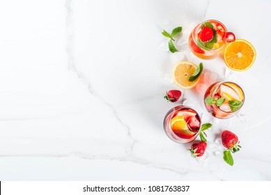 Cold white, pink and red sangria cocktails with fresh fruits, berries and mint. - Powered by Shutterstock