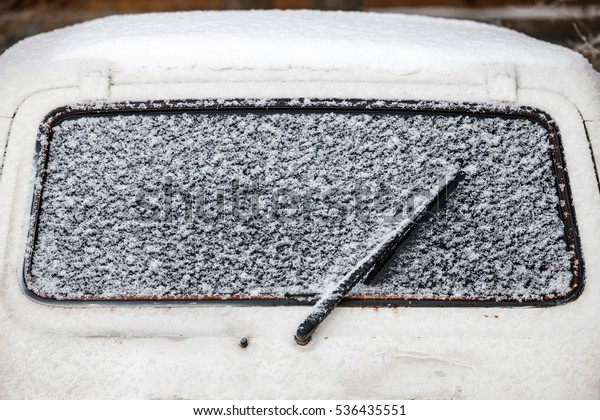 Cold winter. The\
car window under the snow
