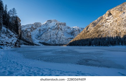 A cold winter morning at a snowy and iced Lake Braies, Province of Bolzano, Trentino Alto Adige, Italy.