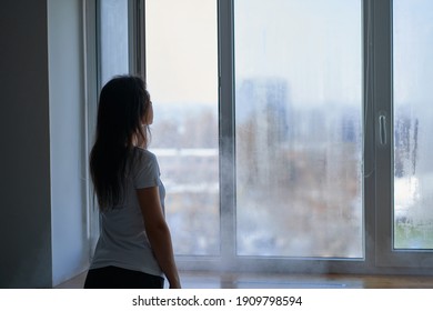 Cold Winter Weather. Woman Step To Window, Open It And Frosty Air Rushes From Outside Through Open Windows To Apartment. Airing Housing In Cold Winter. 