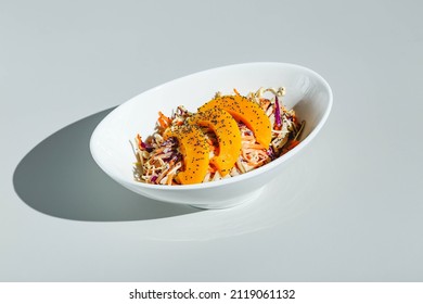 Cole Slow Salad With Mango And Poppy Seeds On Light Background. Hard Light, Deep Shadow.