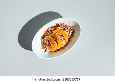 Cole Slow Salad With Mango And Poppy Seeds On Light Background. Hard Light, Deep Shadow.