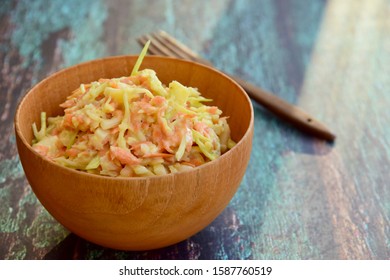 Coleslaw made of freshly shredded white cabbage and grated carrot with homemade vegan mayonnaise salad dressing. Selective Focus 