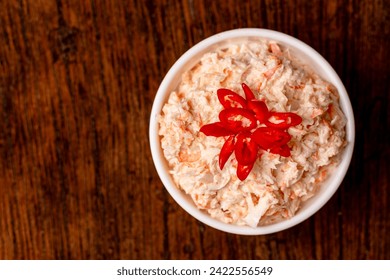 Coleslaw made of white cabbage, carrots, and onions. A white bowl of coleslaw on a wooden background. Healthy eating. - Powered by Shutterstock