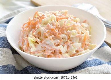 Coleslaw salad with carrot and cabbage on a white bowl. - Shutterstock ID 1873146361